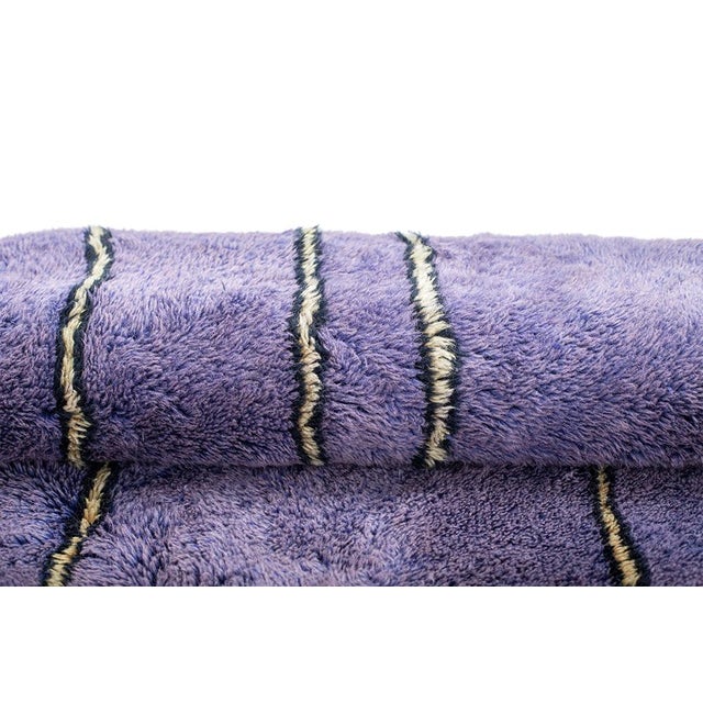 Eye-catching hand-knotted wool rug in vibrant Lavender, Violet, and Lilac tones, featuring intricate Process Yellow and...