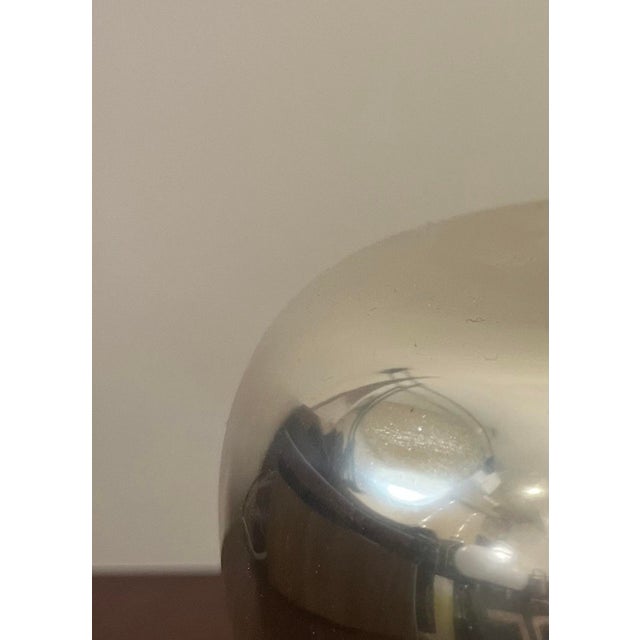 Iconic apple shaped aluminum ice bucket designed by Ettore Sottsass and produced by rinnovel, bears the producer's...