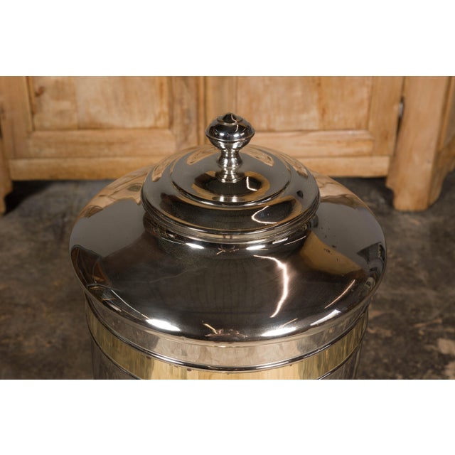 A French Turn of the Century steel and brass coffee bean dispenser from circa 1900. This French Turn of the Century coffee...