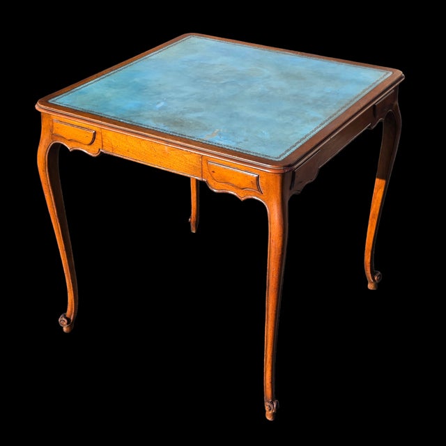 This Beauville Collection by B. Altman & Co. Louis XV Style Walnut Writing Table with Blue Leather Top is a quaintly...