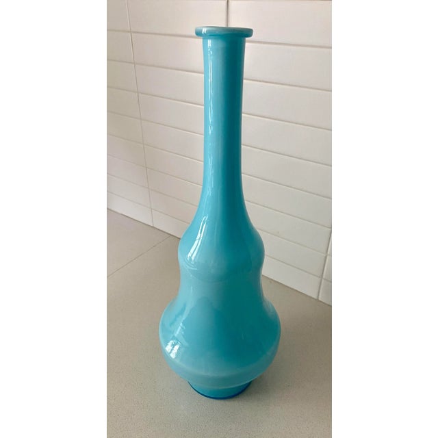 Classic modern cased glass bottle adds dramatic color and height to any collection. Very unusual shape.