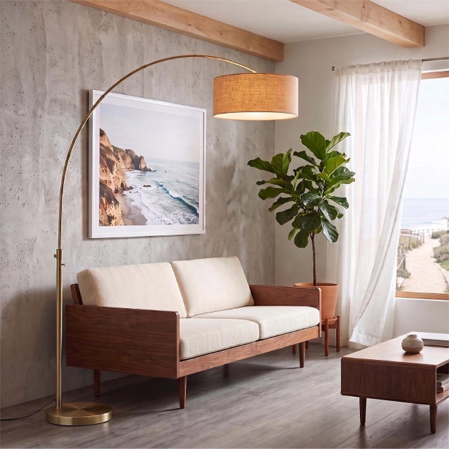 A Peter Morelli original in weathered brass and burlap, designed to float above your favorite room. The Float Arc Lamp is...