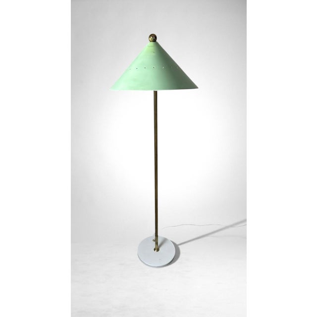 Elegant Italian adjustable floor lamp in brass, featuring a metal lampholder externally lacquered in green and internally...