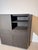 A refined contemporary storage cabinet that combines clean architectural lines with premium materials. Finished in a rich...