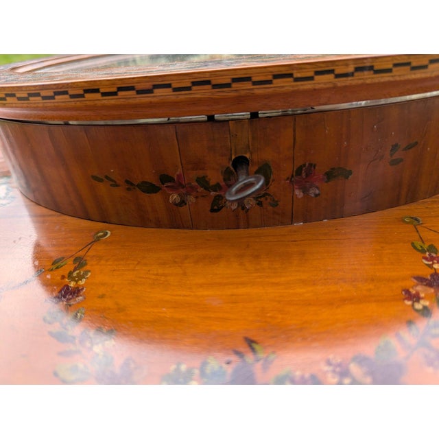 This exquisite Edwardian table dating from the early 20th Century is veneered in satinwood with hand-painted floral...