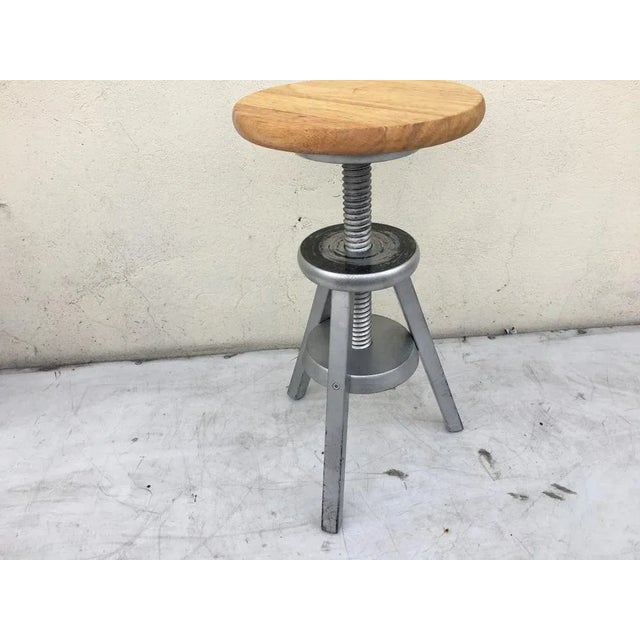Adjustable height tripod stool 1970s Made of solid beech wood stained in silver and the seat left in the natural color of...
