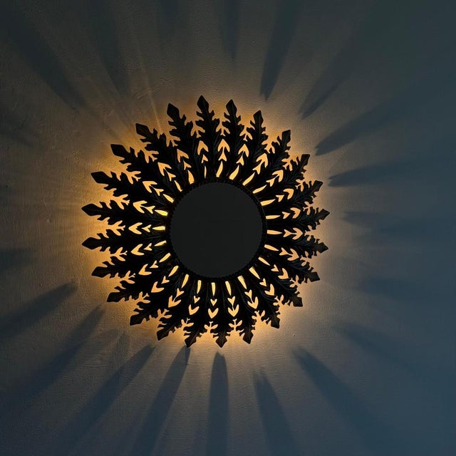 Striking large Italian mirror from the 1970s, conceived as a luminous phytomorphic composition. The circular mirror is...