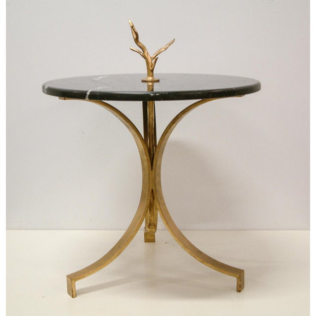 Custom design and hand fabrication of forged and gilt steel occasional table with round black marble top.