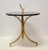 Custom design and hand fabrication of forged and gilt steel occasional table with round black marble top.