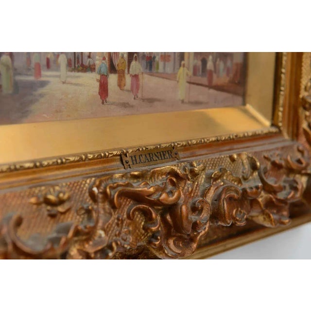 A very fine pair of orientalist oil paintings of middle eastern street scenes- displayed in elaborate period giltwood...