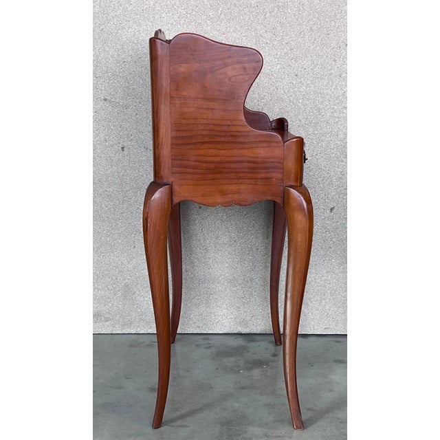 A pretty pair of French one drawer nightstands with open shelf , circa 1910. Pair of French Louis XV style walnut bedside...