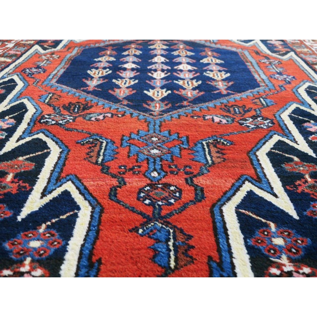 Mid-century hand-knotted rug with a dramatic design on an indigo background. Very good condition with minor signs of age...