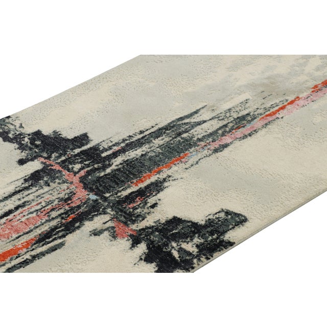 Hand-knotted in a blend of wool and lustrous silk, this 3x7 modern abstract runner rug is a bold new addition to the...