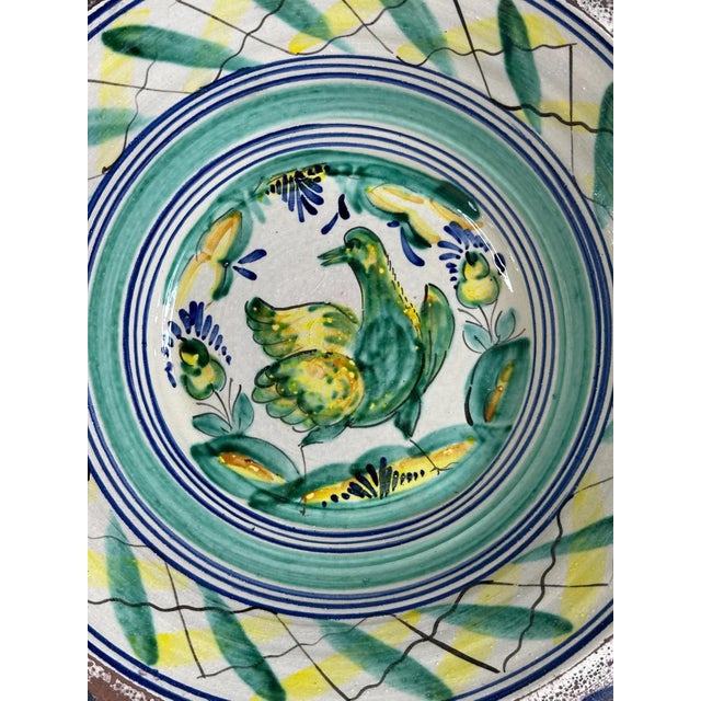 Large basin with a flat base, a very open, truncated cone-shaped eaves and a thick rim from the Seville potteries of...