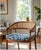 This is a mid-century modern-style bentwood and cane dining armchair with a blue patterned upholstered seat, similar to...