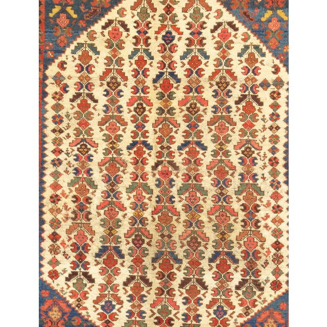 An antique Northwest Persian rug with a beautifully rhythmic allover design of vertically arranged floral and geometric...