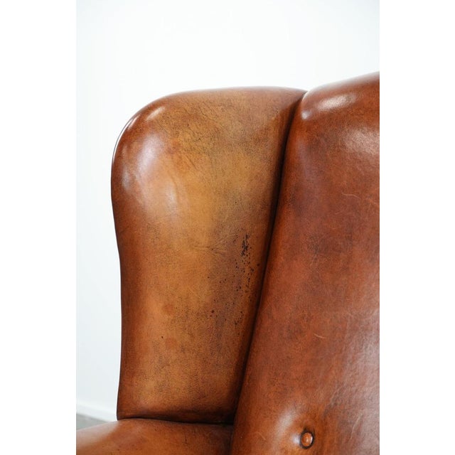 Large Sheepskin Wing Chair with Black Piping and Decorative Nails For Sale - Image 12 of 15