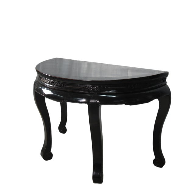 This classic antique Chinese demi lune table was handcrafted with traditional joinery techniques and hand carved in early...