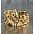 This vintage cuff bracelet is composed of multiple strands of small, rondelle-shaped coconut shell beads, strung in dense...