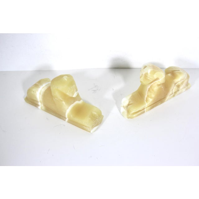 Width: 5.5 inches Height: 3 inches Depth: 1.25 inches Pair of carved alabaster sphinx. These are slightly mismatched. They...
