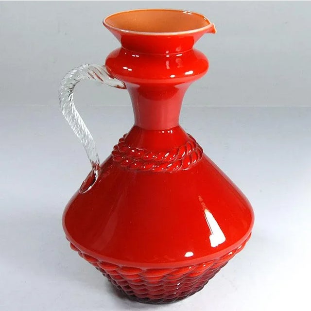 A large vase produced in Empoli in Italy in the 1960s made of hand -formed glass in a very intense orange color, the...