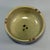 This compact‑sized celadon bowl features soft olive‑green glaze with natural speckled markings. The piece has a neatly...