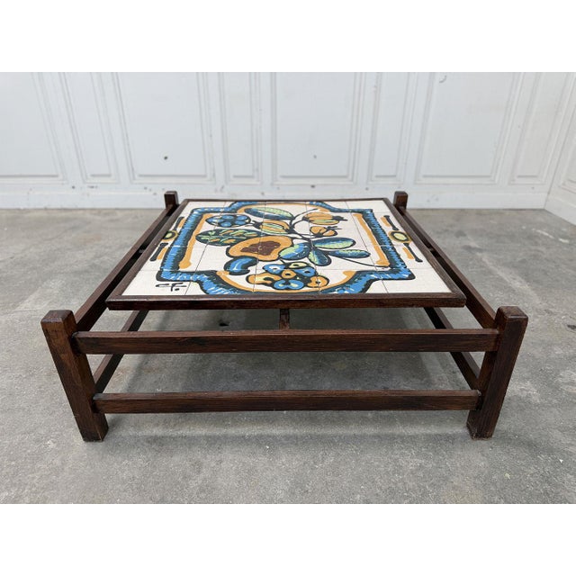 Small vintage coffee table in teak wood and hand-painted ceramic tiles from Brazil. Made in the 1970s, it is striking for...