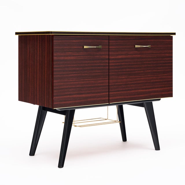 Petite bar cabinet from period mid-century France. This piece is made with a striking Macassar of Ebony veneer. The four...