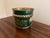 A wonderfully charming early 20th century French tole cachepot finished in an emerald green with delicate gilt...