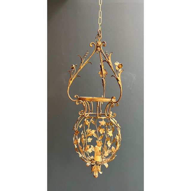 This beautiful, large lantern is made of gilded iron with foliage decoration. It is an Italian creation signed by Palladio...
