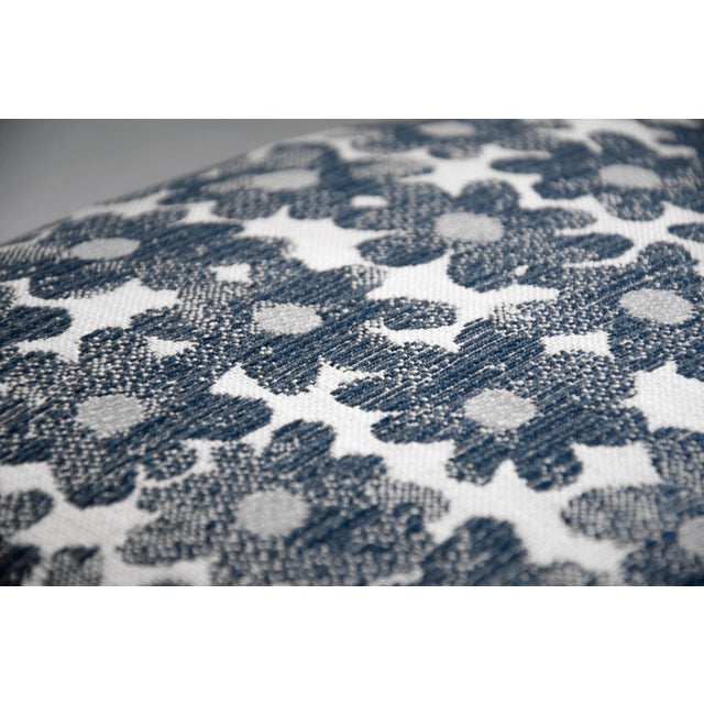 A composition of crisp white daisies blooms across a deep navy ground, their delicate petals rendered with painterly...