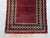 A vintage Afghan Baluch wide runner carrying an all-over boteh (paisley) lattice across a deep oxblood field, framed by...