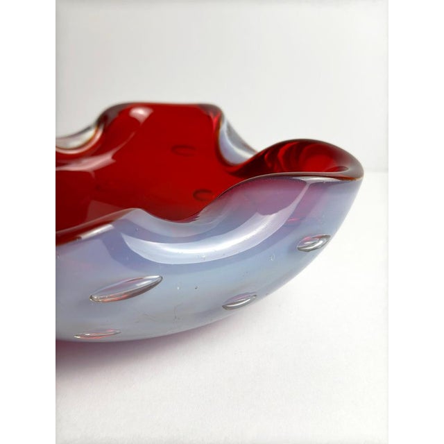 This Murano glass bowl by Alfredo Barbini, produced in Italy during the 1960s, is executed in the sommerso technique, with...