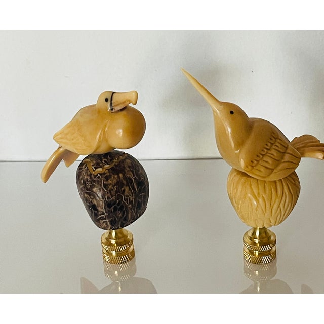 Beautifully carved two bird figurines mounted on brass bases as lamp finials.