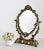 Gorgeous dressing table mirror in heavy full bronze, showing angels (putti) and shells in the frame. Made in Italy in the...