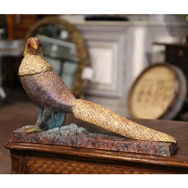 Decorate a ranch house, a hunting lodge or a man's office with this elegant and colorful antique bird sculpture. Crafted...