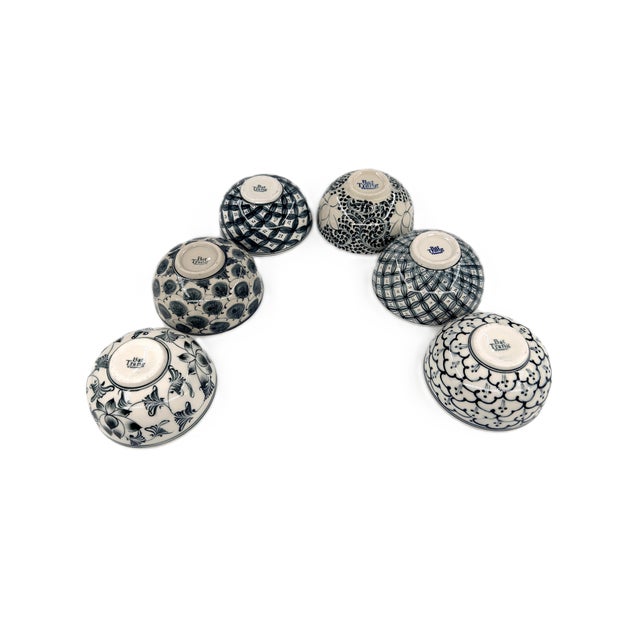 A beautifully curated collection of six handcrafted ceramic bowls from Bat Trang, Vietnam, featuring an assortment of...