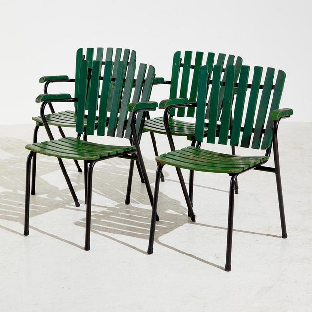 Metal garden armchair with wooden lath seat and backrest. With several surface scratches, paint wear and rust on the metal...