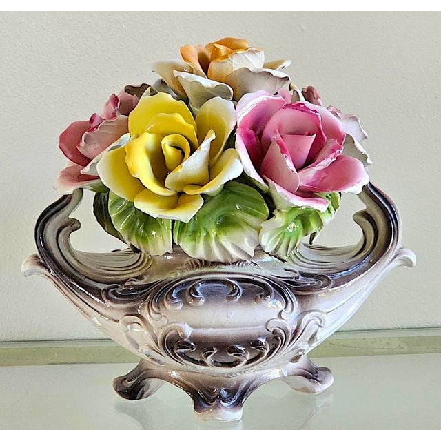 Bring classic Italian elegance to your home with this beautiful vintage Capodimonte porcelain floral centerpiece....