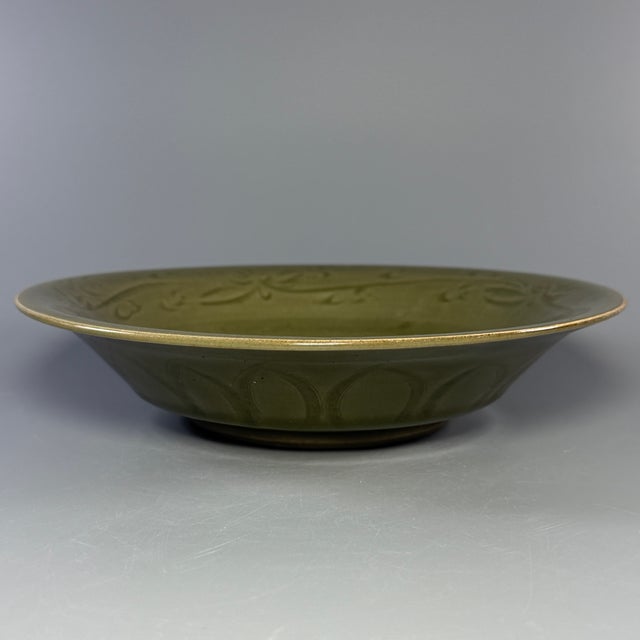 Fine Chinese Longquan celadon carved plate with delicate incised floral patterns on interior. Smooth glaze and elegant...