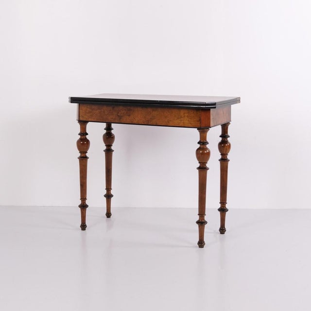 Antique games table crafted in polished mahogany and walnut, dating from the 1860s. The table has a hand-polished finish...