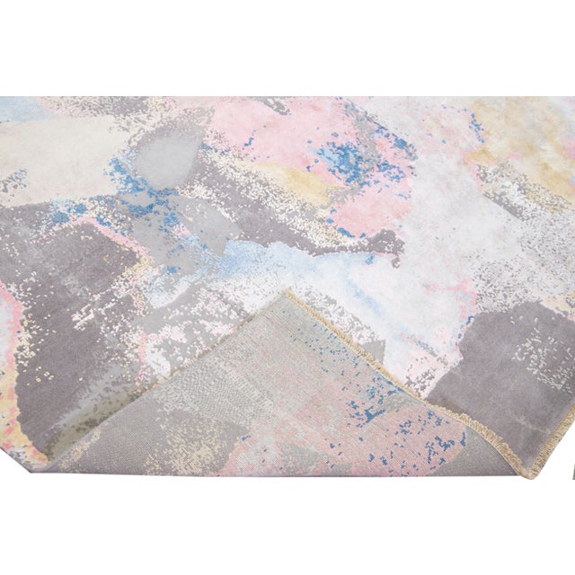 Beautiful modern Indian hand-knotted wool and silk rug with a gray field. This Modern rug has beige, blue, pink, and...