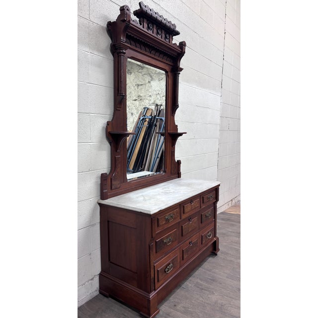 This is a stunning antique Victorian Eastlake walnut dresser, circa 1870–1890, featuring figured burl panels, a white...