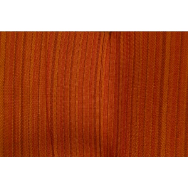 Model FB05 Lounge chair by Cees Braakman for Pastoe. The chair comes with an orange fabric upholstery on the seating and...