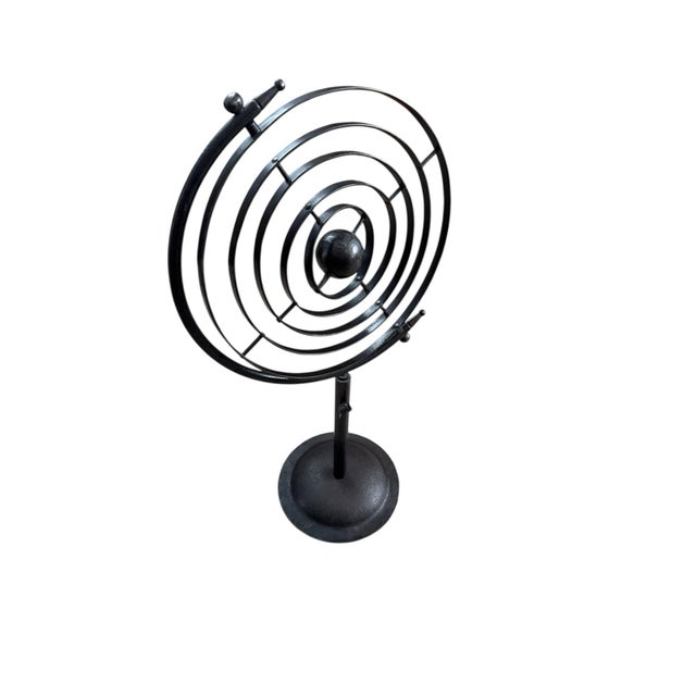 Vintage Mid Century wrought iron armillary sphere with a center sun surrounded by 5 movable planetary rings on a platform...