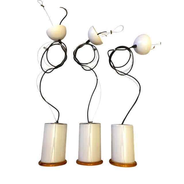 A lovely simple yet elegant set of three canister style hand blown glass pendant lights from Italian lighting company I3...