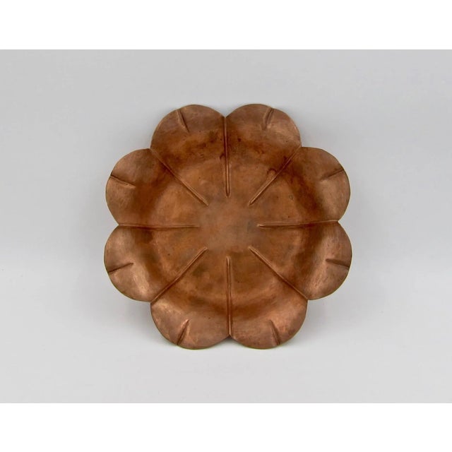 An antique floriform shallow bowl or dish in copper by American silver and metalsmith Marie Zimmermann (1879-1972). The...
