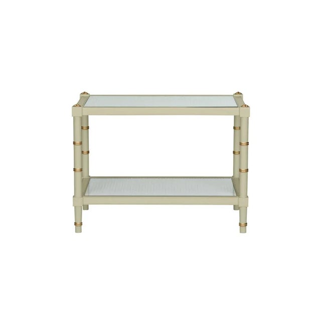 The Connor Cocktail Table in green is adorned with gold hand painted detailing around the edge of the bamboo-inspired legs...