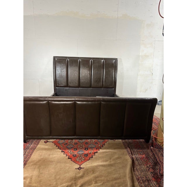 Make your bedroom feel instantly more finished with this contemporary California King upholstered leather bedframe. The...