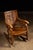 Antique quarter-sawn oak rocker with a carved panel splat. This unique piece depicts a scene wherein two monks appear to...